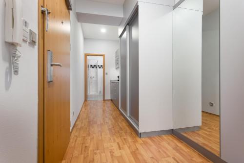 a hallway with white walls and a wooden floor at Apartmány Kramer in Opava
