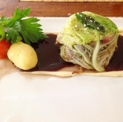 a sandwich on a plate with chocolate sauce and strawberries at Logis Hôtel Restaurant Du Lion D'argent Et Des Tanneries in La Châtre