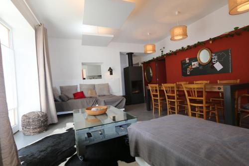 a living room with a couch and a table at Le postillon REZ in Saint-Pierre-dʼEntremont