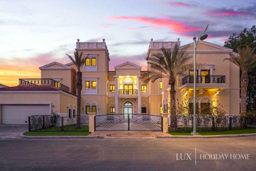 a large house with a fence in front of it at LUX - The Dubai Paradise Palace in Dubai