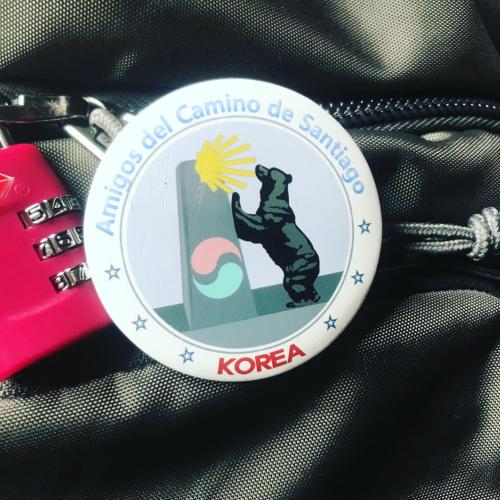 a badge with a picture of a bear on a strap at SEÑOR OSO in Molinaseca