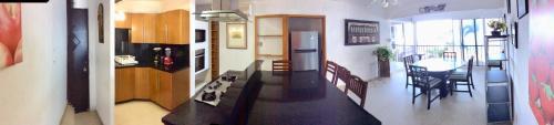 a kitchen and living room with a stove and a table at Suites Atlas - Ocean Front in Bucerías