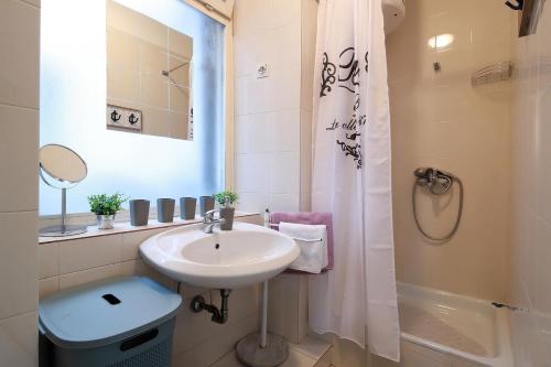 a bathroom with a sink and a shower at Retreat in Rijeka