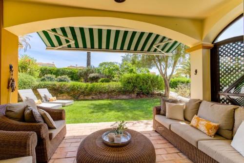 a patio with a couch and chairs and a table at 2bedroom bungalow on Gramacho Golf Resort heated shared pool in Carvoeiro