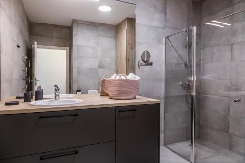 a bathroom with a sink and a shower at Apartment Hotel Laisve in Druskininkai