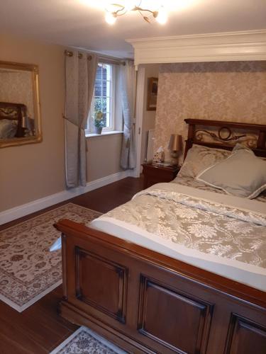 a bedroom with a large bed and a window at Riverside Lodge in Carlingford