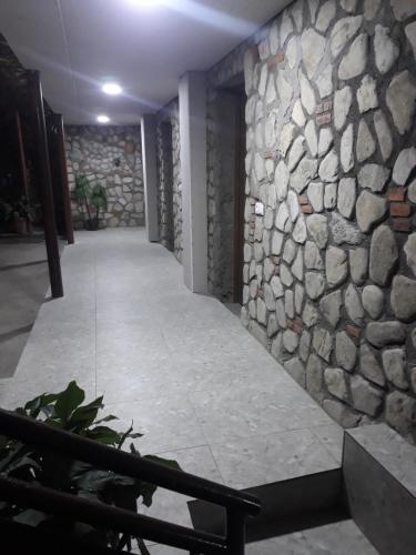 a room with a stone wall and a hallway at Hotel E U R O P E in Kvareli