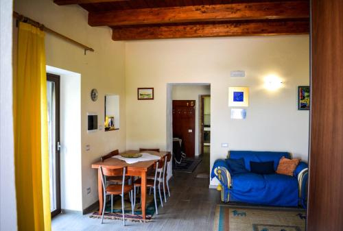 a living room with a blue couch and a table at Due Passi B&B in Marano Marchesato