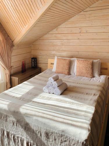 a bedroom with a large bed with towels on it at Villa Kaiser in Lviv