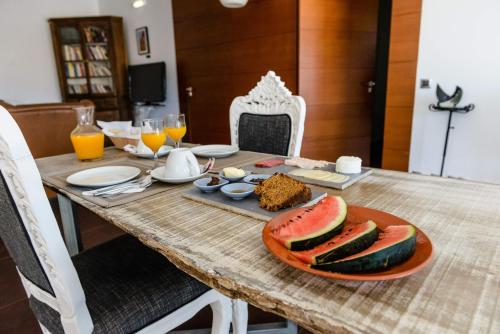 a wooden table with a plate of food on it at Monte Do Malhao - Art, Eco & Spa in Castro Marim