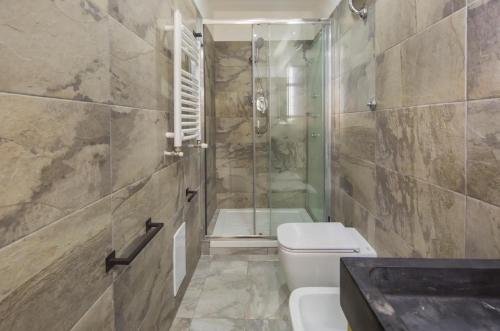a bathroom with a shower and a toilet and a sink at VILLA FUENTI BAY -Amalfi Coast- in Cetara