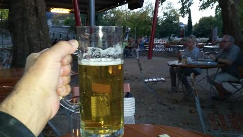 a person holding up a glass of beer at WALDHOTEL in Dierdorf