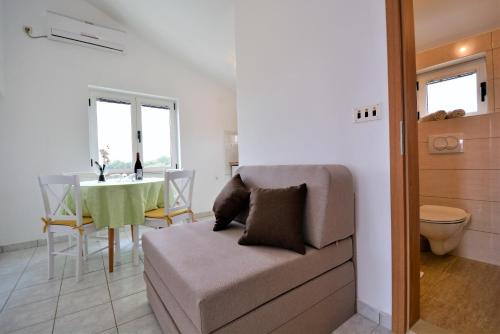 a living room with a couch and a table at Villa Allegro in Sukošan