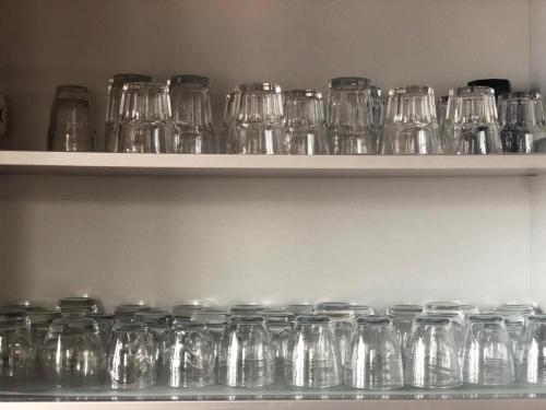 a bunch of glass jars sitting on a shelf at VILLA FUENTI BAY -Amalfi Coast- in Cetara