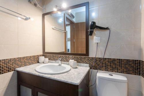 a bathroom with a sink and a mirror and a toilet at Gianni Holiday Home in Pieta