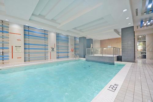a large swimming pool in a building at PlanURstay - Luxury Suites Mississauga Downtown in Mississauga