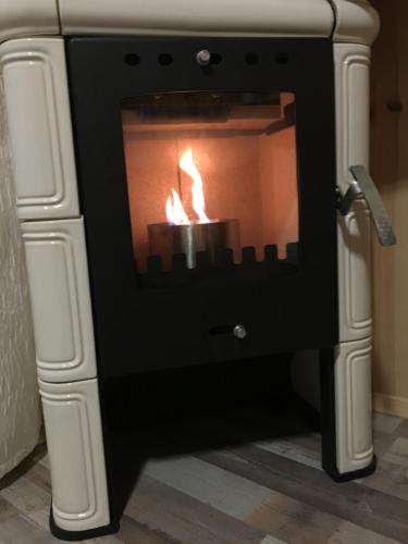 a fireplace with a fire in it at Relax villa Poduzska in Sinyak