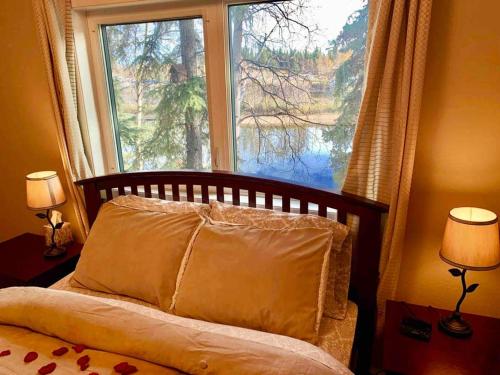 a bedroom with a bed with a large window at #2 LUX STAY - Views - Water Front-Location/Aurora in Fairbanks