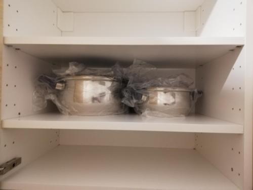 two pots sitting on a shelf in a refrigerator at Central in Patra