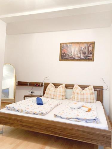 a bedroom with a bed with two pillows at Pension Huber in Klosterneuburg
