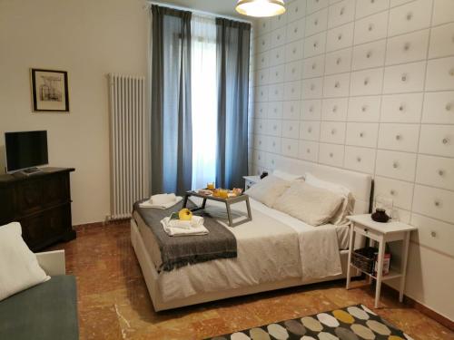 a bedroom with a bed with a table on it at Residenza Rialto in Bologna