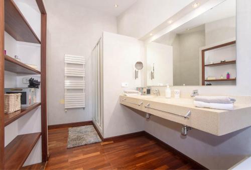 a bathroom with a large mirror and a sink at Ca’n Roega in Sóller