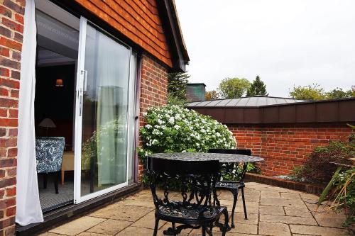 a patio with a table in front of a building at Fredrick's Hotel Restaurant Spa in Maidenhead