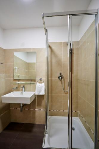 a bathroom with a shower and a sink at Penzion a restaurace Bílý Mlýn in Liberec