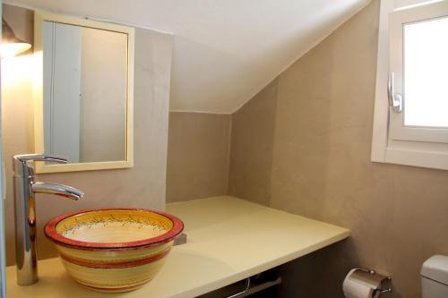 a bathroom with a sink and a mirror at Stunning Sunset House on Kamares Bay with Playground in Kamarai