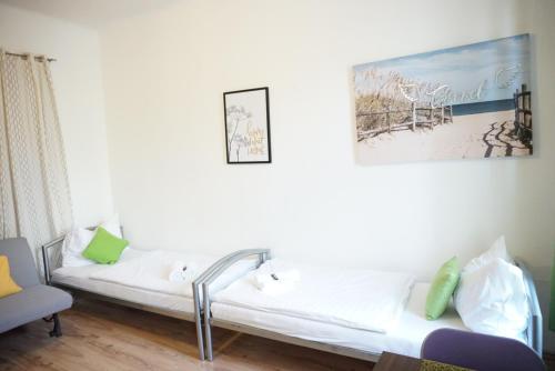 ein weißes Sofa in einem Zimmer mit einem Gemälde an der Wand in der Unterkunft Contactless Check-In Room4You Währing in Wien