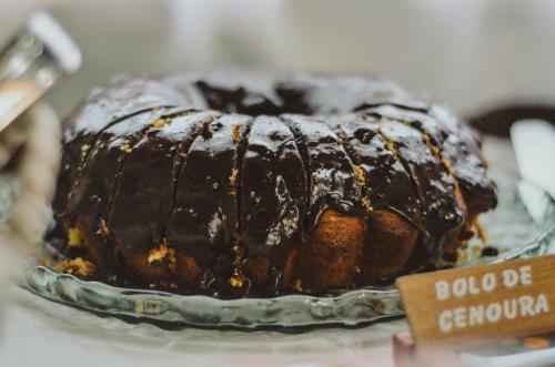 a chocolate cake on a glass plate on a table at Pousada Vila dos Butias in Urubici