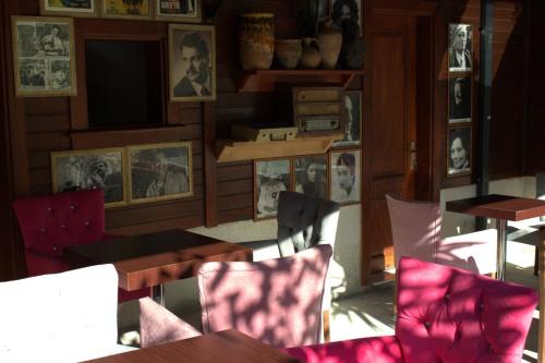 a restaurant with tables and chairs and pictures on the wall at QONAQ HOTEL & SUITES in Istanbul