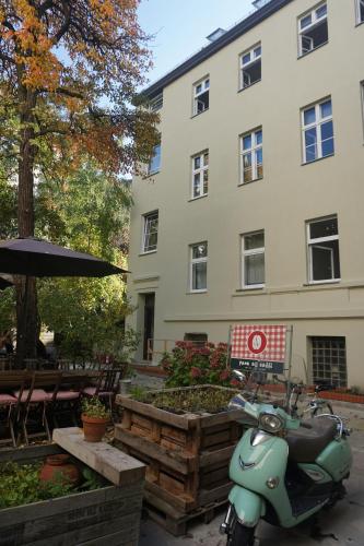 a scooter parked in front of a building at Madflats Hotel-Apartments S-Bahn Friedenau in Berlin