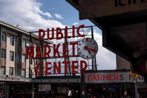 a large sign for a market center with a clock at Four Seasons Hotel Seattle in Seattle