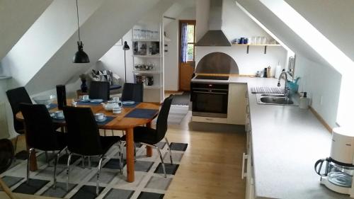 a kitchen and dining room with a table and chairs at Ferie Lejligheden Landlyst in Rødvig