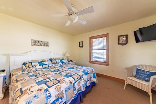 a bedroom with a bed and a ceiling fan at Sea Shellter in Whalebone
