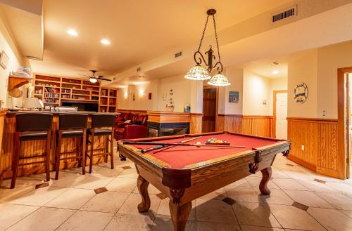 a pool table in a room with a bar at Sea Shellter in Whalebone