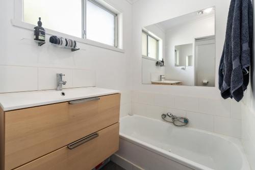 a bathroom with a sink and a tub and a mirror at Badenoch in Blairgowrie