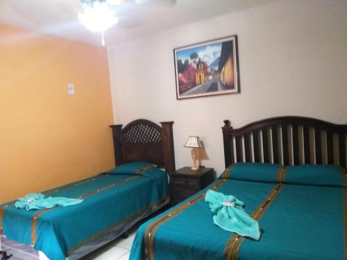 Una cama o camas en una habitación de Hospedaje El Viajero Antigua