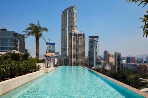 a swimming pool on the roof of a building with a city at K11 ARTUS in Hong Kong