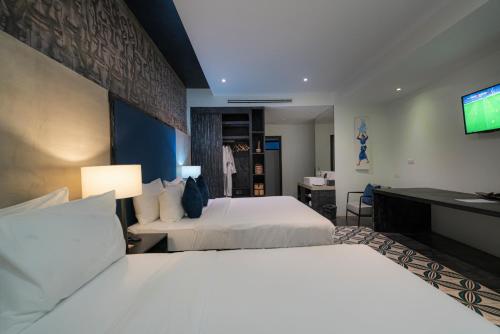 Ένα ή περισσότερα κρεβάτια σε δωμάτιο στο Monthara Angkor Residence