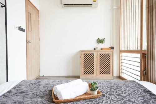 a bedroom with a bed with two pillows on it at Vann Bangkok Boutique House in Bangkok