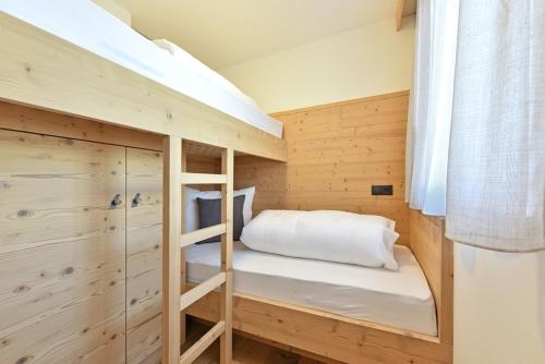 a small room with a bunk bed in a cabin at Forchnerhof - 3 Täler Blick in Rodengo