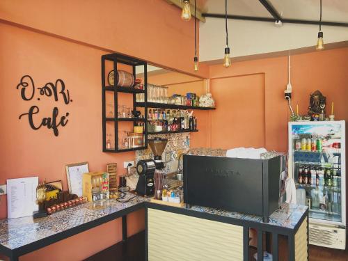 a coffee shop with a counter in a room at Assasa Huahin in Hua Hin