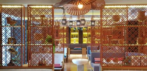 a restaurant with a room with a table and chairs at Bizotel Premier Hotel & Residence in Bangkok