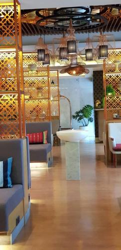 a room with couches and a table and some lights at Bizotel Premier Hotel & Residence in Bangkok