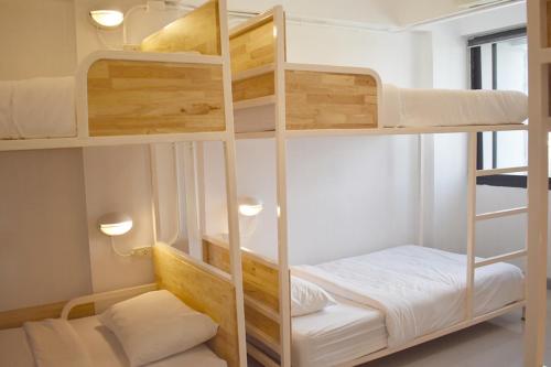 a room with two bunk beds in a room at Loyy Hotel in Chiang Mai