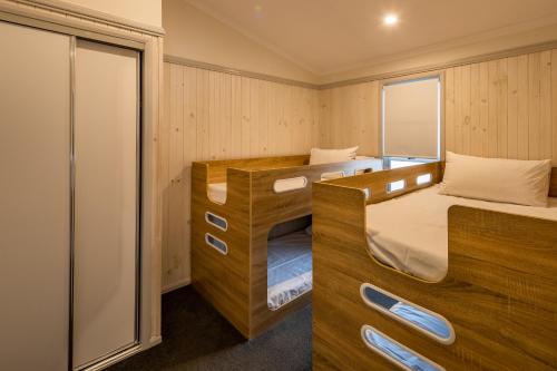 a small room with two bunk beds in it at Ingenia Holidays Nambucca Heads in Nambucca Heads