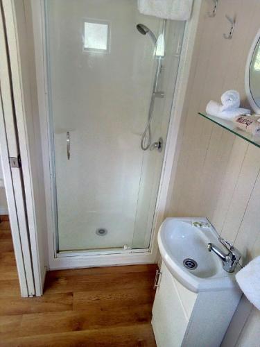 a bathroom with a shower and a sink at Opunake Beach Holiday Park in Opunake