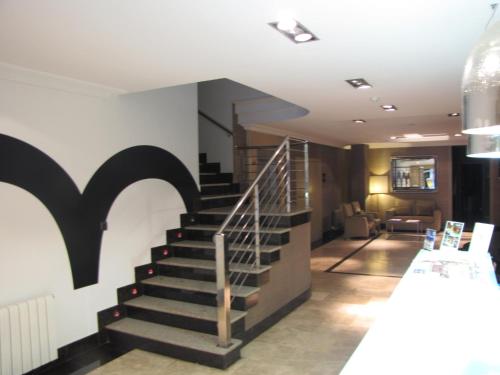 a spiral staircase in a lobby with a living room at Hotel Room in Pontevedra